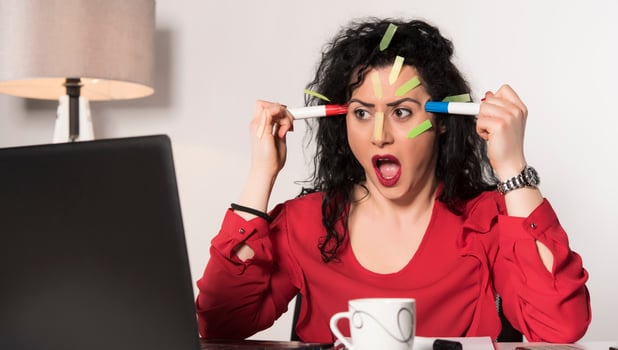 Pretty female model with a lot of post it notes working in her office. photo