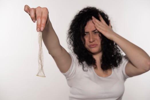 woman holding condom. save sex concept. isolated photo