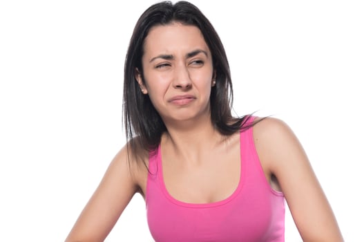 Young beautiful woman has headache, isolated on gray background. Exhausted girl portrait photo