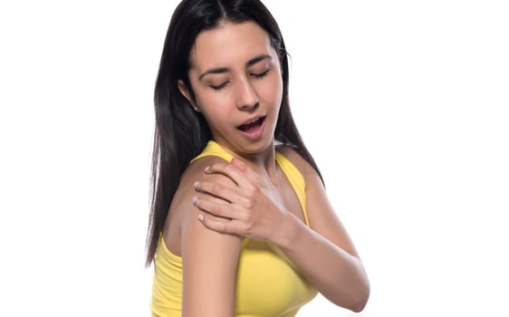 The person feels pain in the arm and shoulder and massages. photo