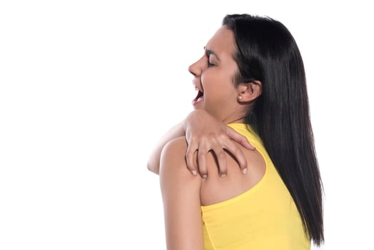 Sports injury concept. Athletic woman feeling pain in her neck and shoulder photo
