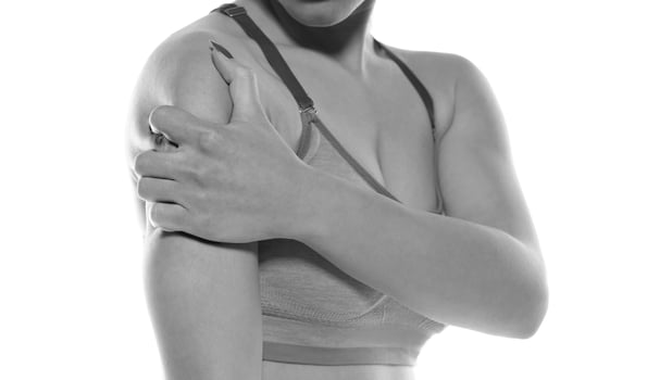 The person feels pain in the arm and shoulder and massages. photo