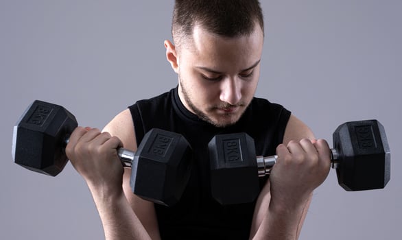 male holding  dumbbells photo