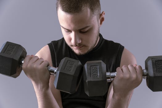 male holding  dumbbells photo