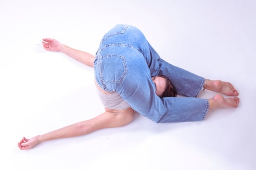 Portrait of beautiful young woman with athletic flexible body doing leg stretching. isolated photo