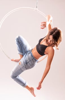 A female Aerial hoop gymnast  performing exercises on an Aerial hoop photo