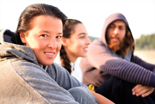friends relaxing on the beach and talking photo