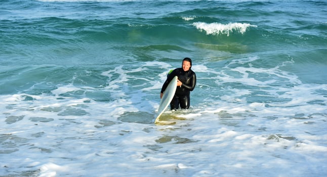 Beautiful surfer girl on the beach photo