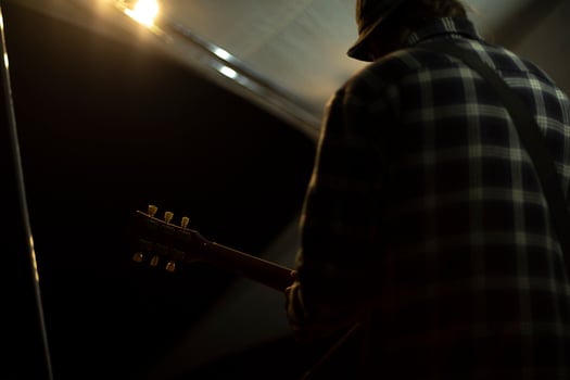 Musician on stage. Guitarist performs at festival. Details of music festival. photo