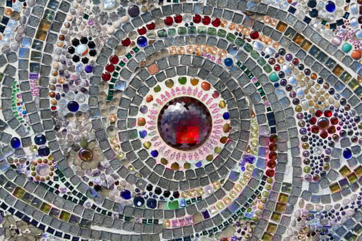 Many jewel or gem, colorful gravel and red diamond in middle or center decorated on wall for background. Pattern of stone or mosaic wallpaper at Thai temple. Art design photo