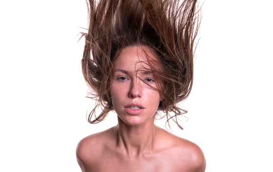 Portrait of a beautiful woman with a long hair. Young brunette model with beautiful hair - isolated on white background. Young girl with hair flying in the wind. photo