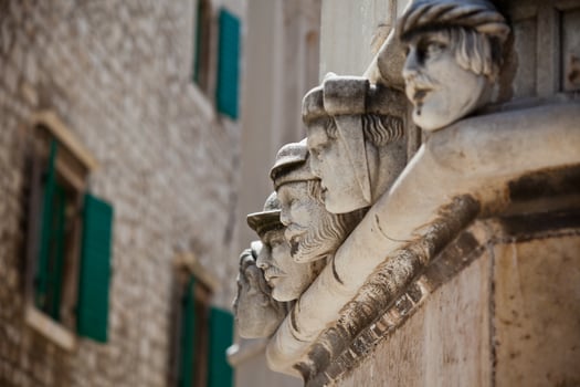 Stone heads at Cathedral of St. James in Sibenik, Croatia photo