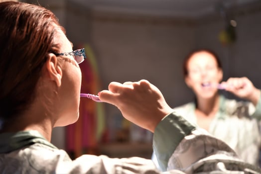 Lady Brushing Teeth With Toothbrush Standing In Bathroom Indoor photo