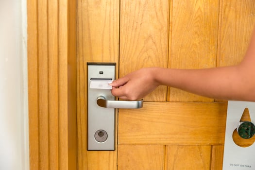 Close up of female hand hold key card and open electronic lock door photo