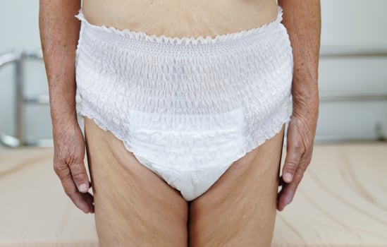 Asian elder senior woman patient wearing adult incontinence diaper pad in hospital. photo