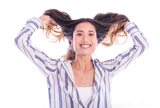 Young Asian woman playing with her hair photo