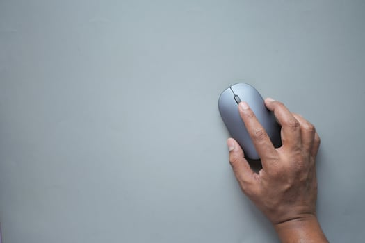 top view of person hand using mouse on gray background photo