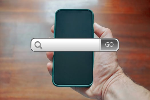 hand holding a smart phone searching on internet photo