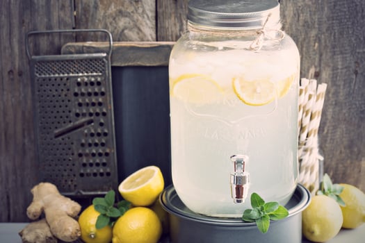 Ginger homemade lemonade in a beverage dispencer photo