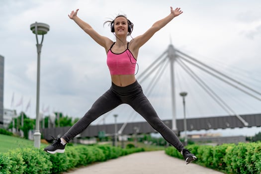 Sports woman jumping of joy till exercise. photo