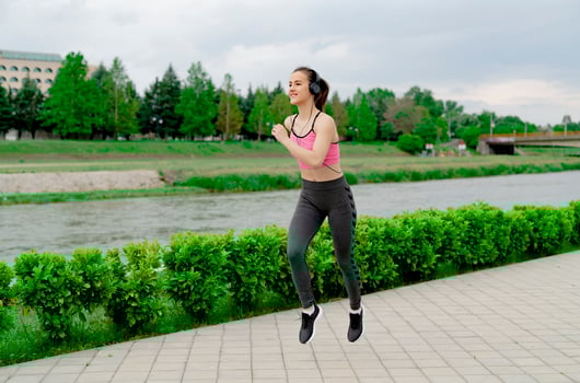 Sports Woman jogging down at urban outdoor trail. photo