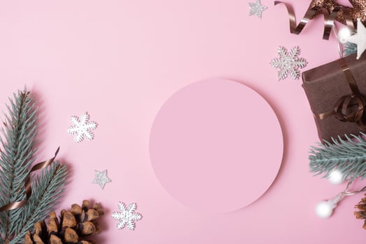 Podium or pedestal for beauty products or text with Christmas decorations top view on pink background top view photo