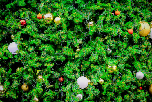 Background for Christmas season. Close-up shot of a beautiful decorated fir tree. photo