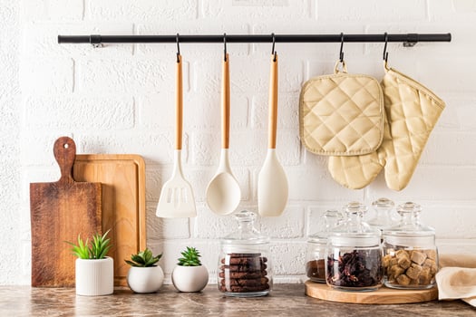 beautiful storage area on a modern kitchen countertop. various glass jars with bulk products. wooden boards. kitchen holder, railing photo