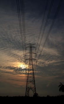 High-voltage poles are used to carry electricity for industrial plants and people to use in the farmer's fields in the evening. Beautiful sky atmosphere and designed by electrical engineers. photo