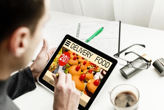 Hipster man hands holding digital tablet with app delivery food screen photo