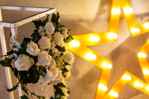 Wedding reception decoration with different electric edison lamps and fresh flowers, rustic style photo