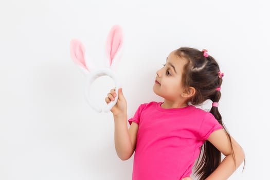Happy lost tooth little girl wearing funny bunny ears photo