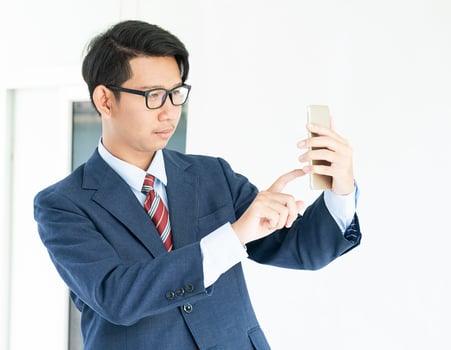 Business man holding smartphone photo