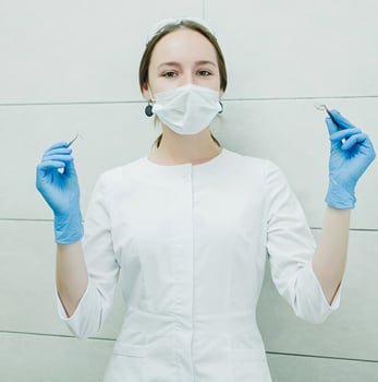 a female dentist in a white coat photo