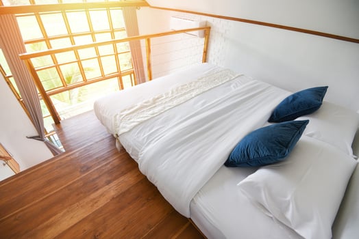 bedroom interior design white and wooden floor - morning bedroom with sunlight and nature view on window photo