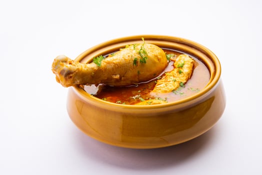 Red Chicken Curry or murgh Masala or korma with prominent Leg Piece photo