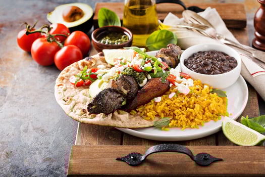 Beef kebab with rice, beans and fried plantains photo