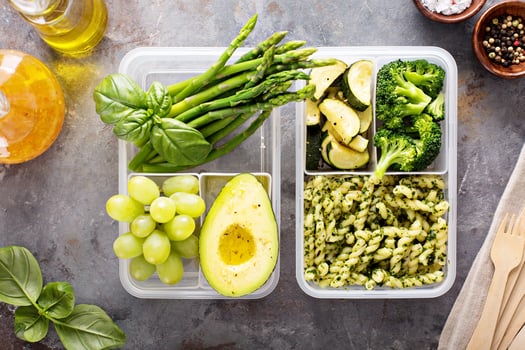 Vegan meal prep containers with pasta and vegetables photo