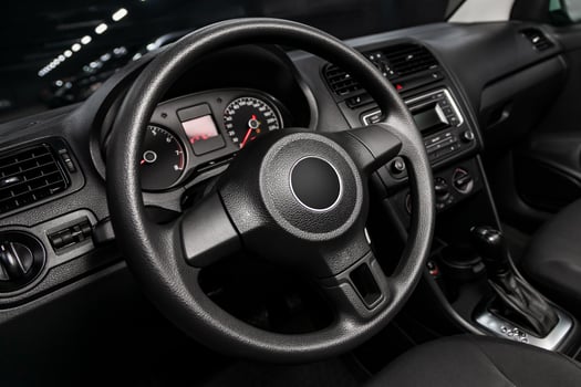 dashboard, speedometer, tachometer and steering wheel with wooden inserts with phone setting and volume buttons. Luxurious car interior details photo