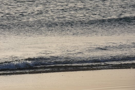 lonely, uncrowded beach with calm sea and small waves photo