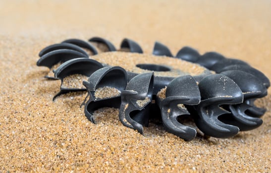 Plastic Pelton water turbine on sand with out water photo