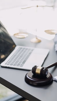 Male lawyer working with contract papers and wooden gavel on tabel in courtroom. justice and law ,attorney, court judge, concept. photo