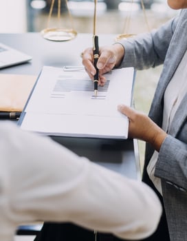 Business and lawyers discussing contract papers with brass scale on desk in office. Law, legal services, advice, justice and law concept picture with film grain effect photo