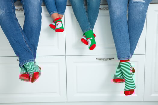 the concept of a happy family dressed in Christmas stockings in the kitchen photo