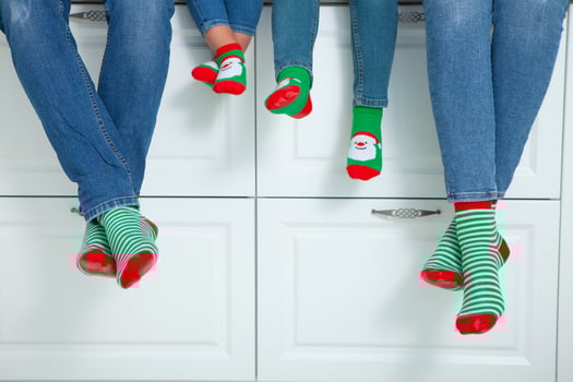 the concept of a happy family dressed in Christmas stockings in the kitchen photo