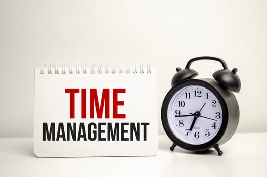 time management words with calculator and clock with notebook photo