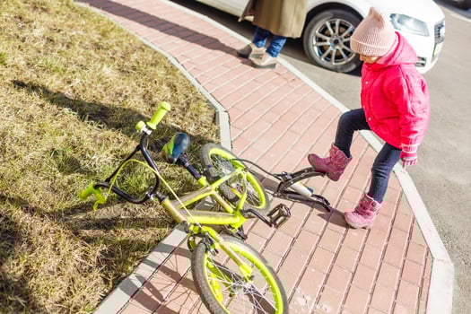 inflating a tyre of her bicycle, closeup shot photo