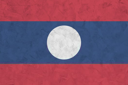 Laos flag depicted in bright paint colors on old relief plastering wall. Textured banner on rough background photo