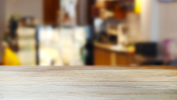 Wooden table with a blur cafe background with an aesthetic interior atmosphere photo