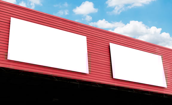 Mock up billboard on building with blue sky background photo